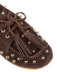 Close-up of the Dolci Firme Dodi chocolate suede loafer showing the suede tassel lace, gold eyelets and gold dome studs