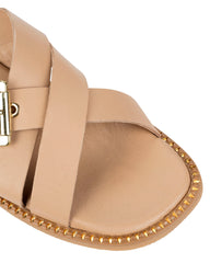 Close-up of the oversized gold squared buckle and gold studs tracing the sole edge on the Dolci Firme Lilla nude slide