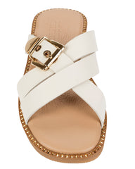 Dolci Firme Lilla milk leather slide, top view showing the crossover straps, gold squared buckle and studded sole edge