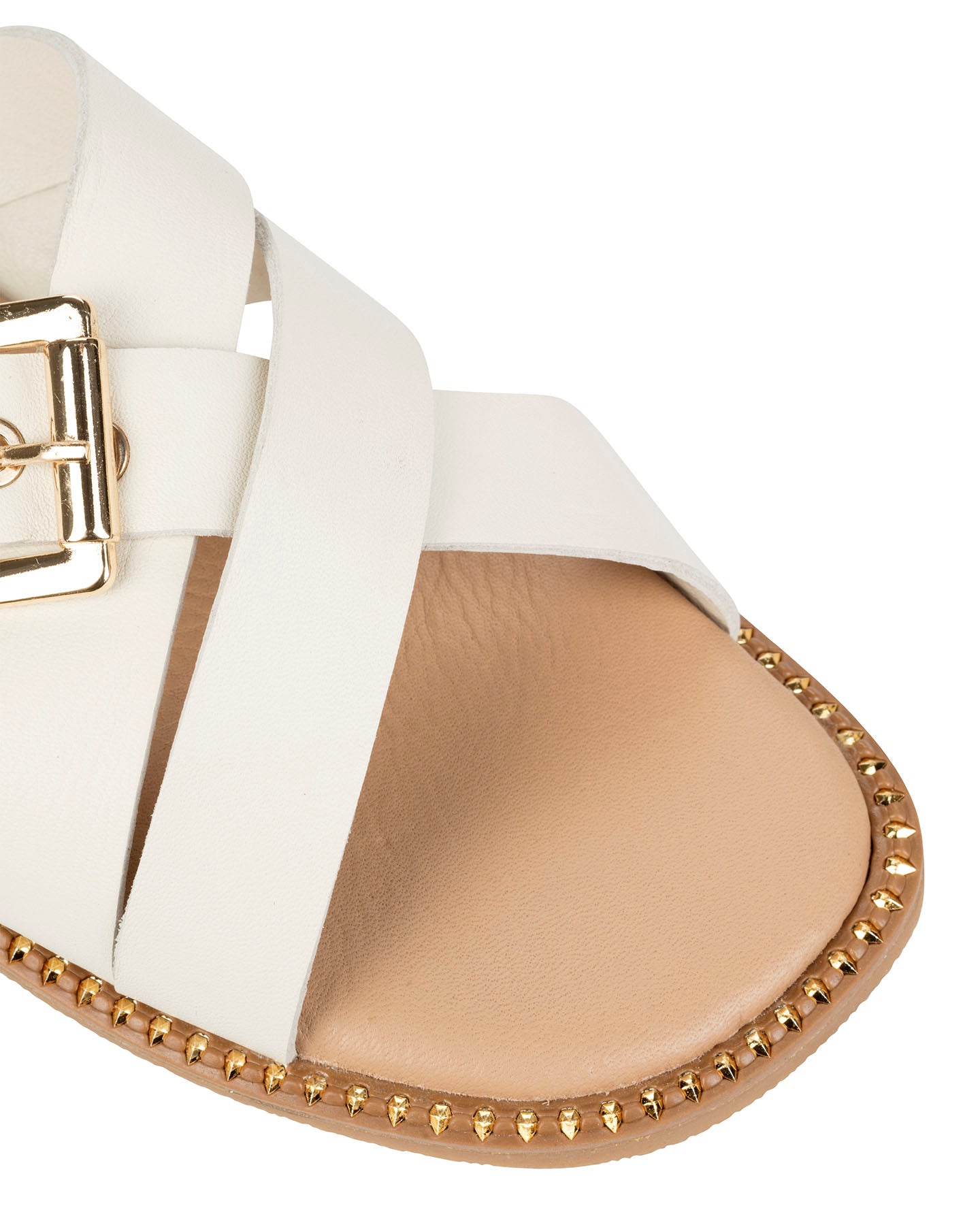 Close-up of the oversized gold squared buckle and gold studs tracing the sole edge on the Dolci Firme Lilla milk slide