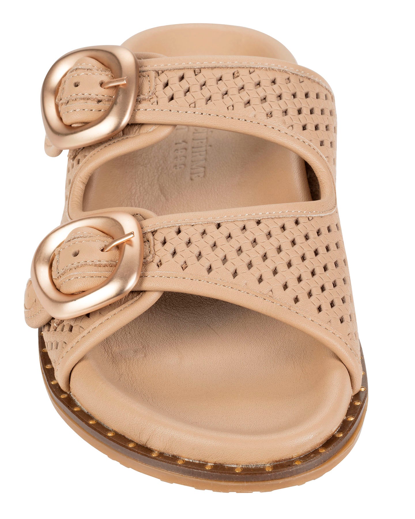 A single women's slide sandal from the brand Dolci Firme , shown from a top-down view. The sandal features two wide straps with a textured, perforated pattern and large, round rose gold-tone metal buckles.