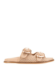 A single flat slide sandal in a light tan leather with perforated detailing and two large rose gold buckle straps, shown from a side profile on a white background.