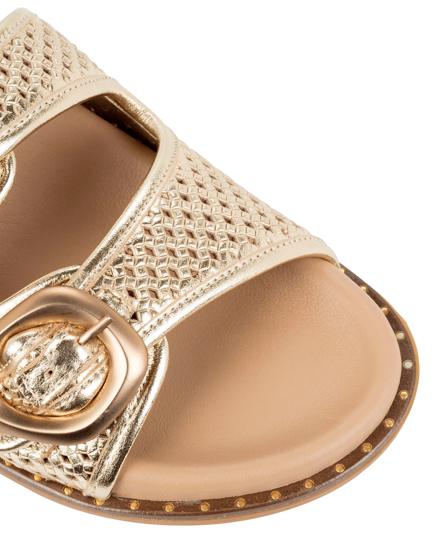 Close-up of the woven gold leather strap, ring buckle and studded sole edge on the Dolci Firme Beaty slide